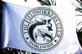 c8133147d976d89092c838c4cf45532f White flag with "The Fieldworkers Club Worldwide" logo featuring tools, fish, and nature imagery, against a backdrop of palm leaves.